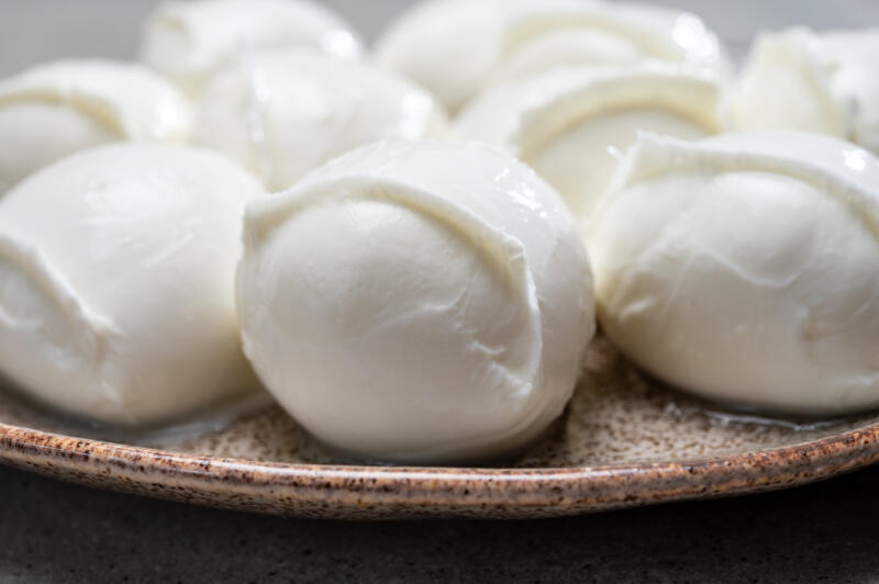 A plate with several fresh mozzarella cheese