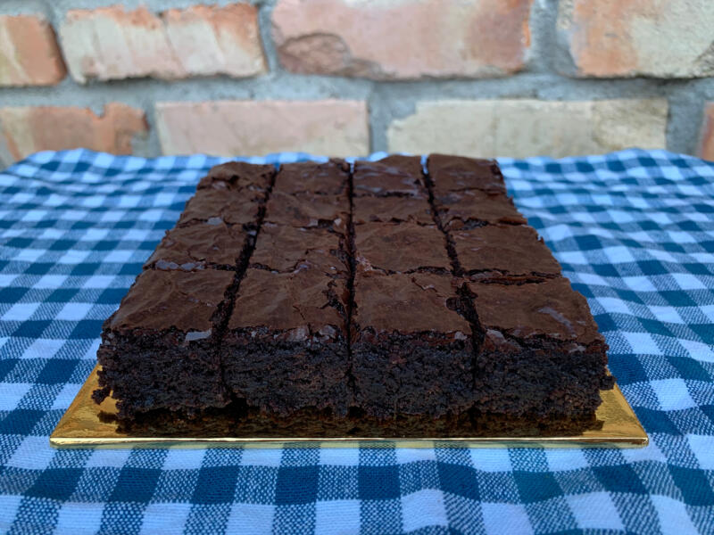 Homemade fudgy brownies on a blue tablecloth