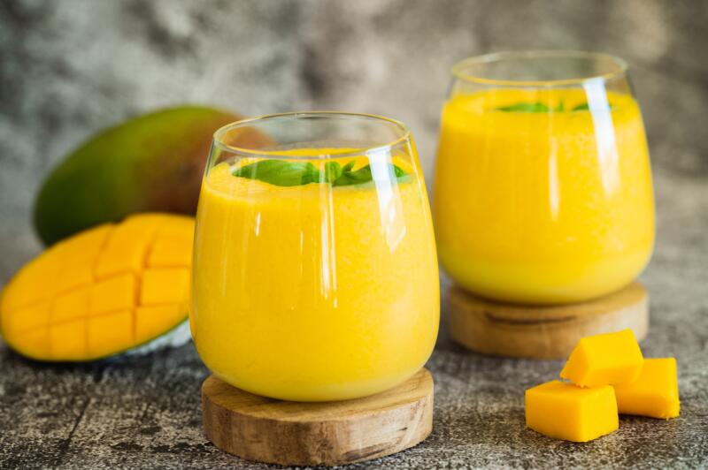 Fresh mango lassi in two glasses on the table