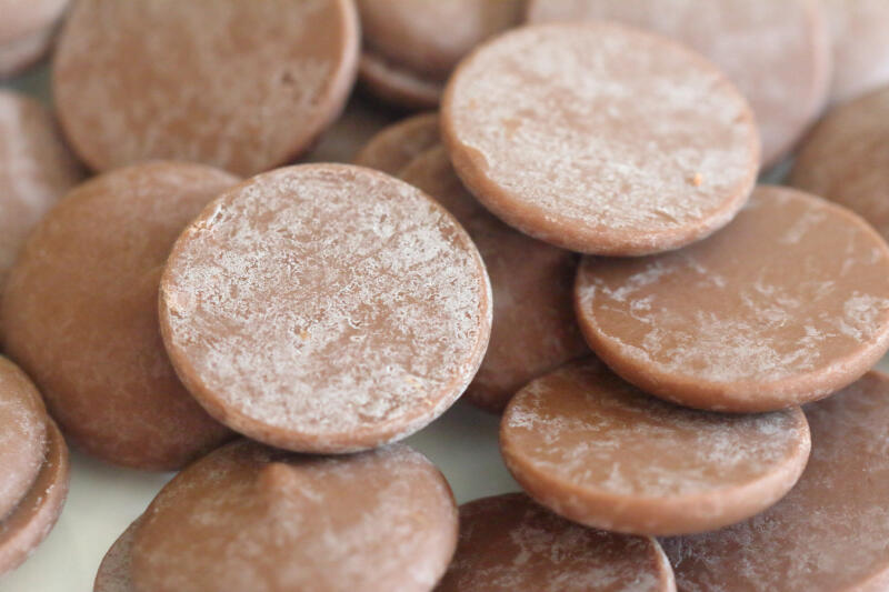 Chocolate chips exhibiting fat bloom on the surface