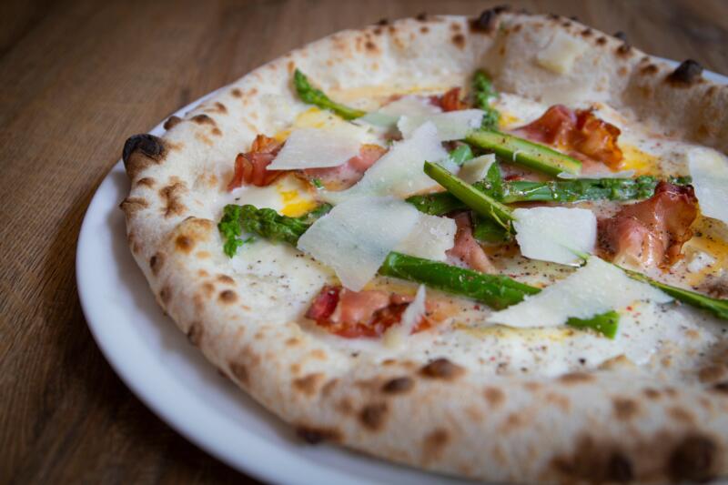 A pale Neapolitan style pizza without browning color on a plate