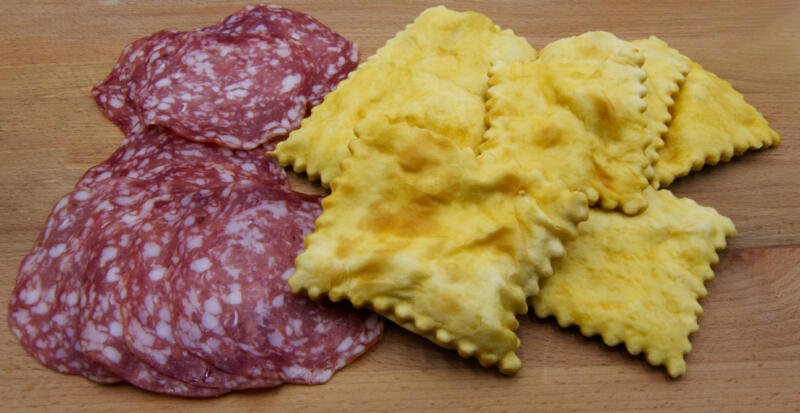 Gnocco fritto or Crescentine with slices of salami, traditional italian food from Modena
