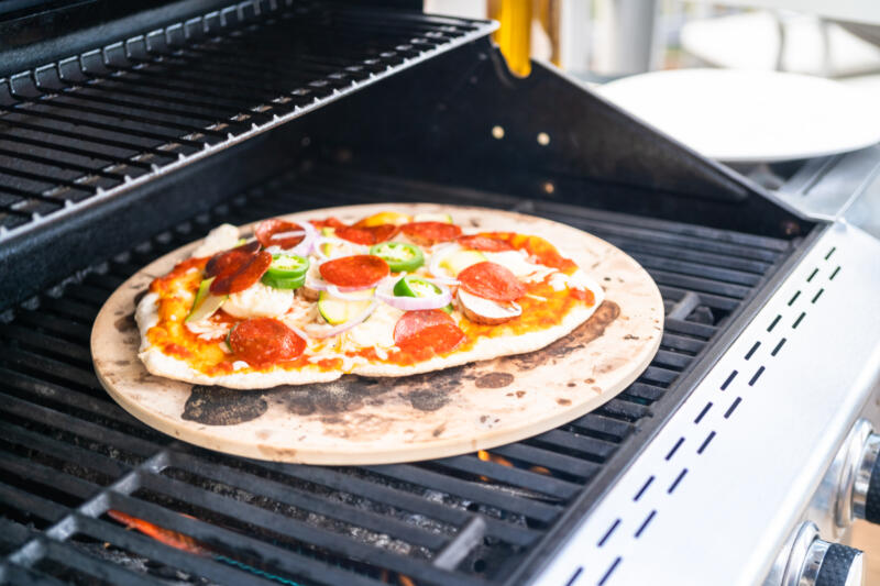Cooking pizza on a used, stained pizza stone