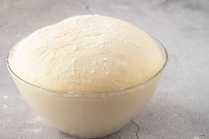 Fresh rised dough in a glass bowl