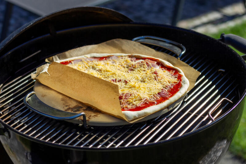 Pizza cooking on a pizza stone 