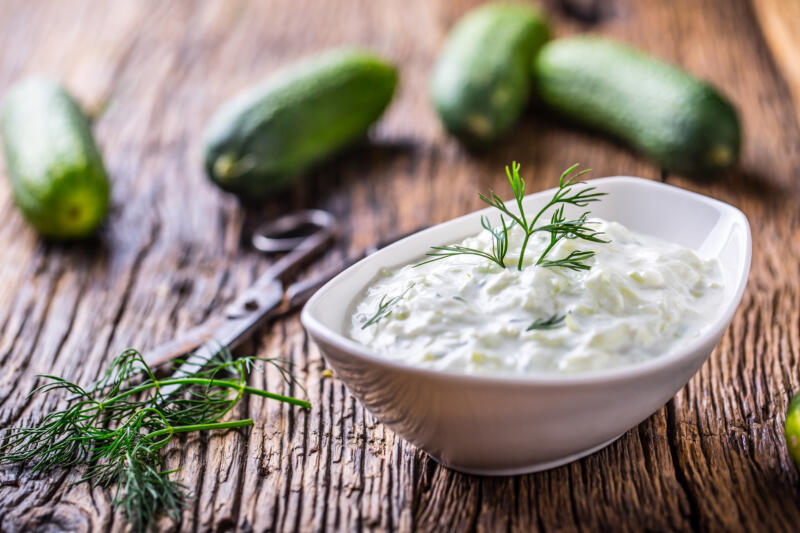Traditional greek dip sauce or dressing tzatziki prepared with grated cucumber sour cream yogurt olive oil and fresh dill