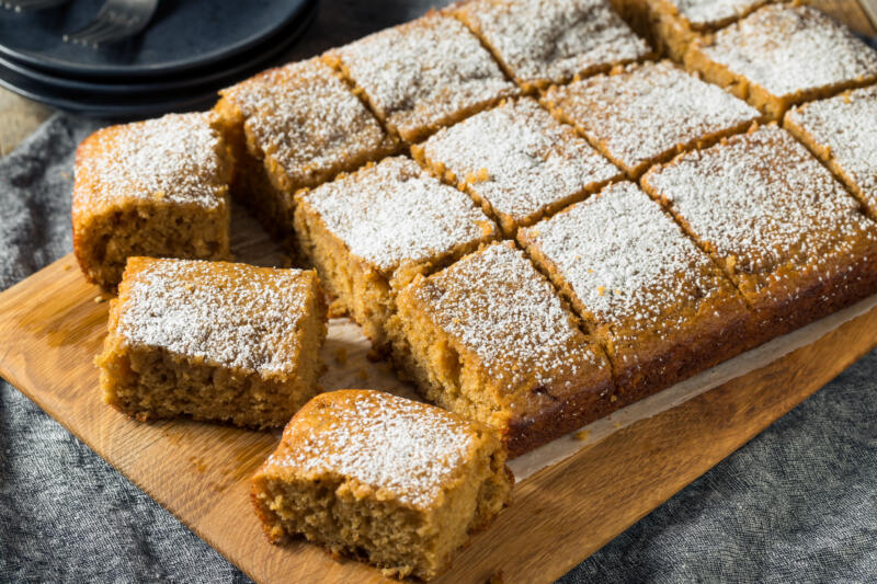 Freshly baked sliced homemade applesauce cake powdered with sugar