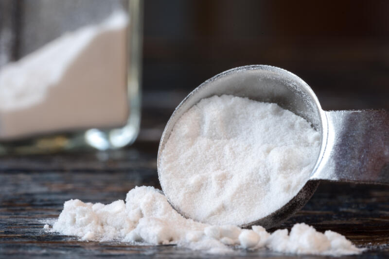 Arrowroot starch spilled from a spoon on a table