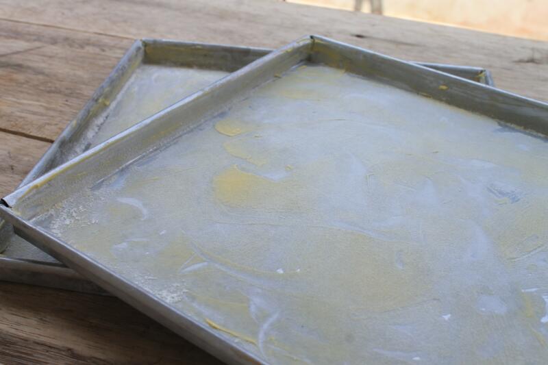 A baking sheet that has been smeared with margarine and flour on the table is ready to be used for baking