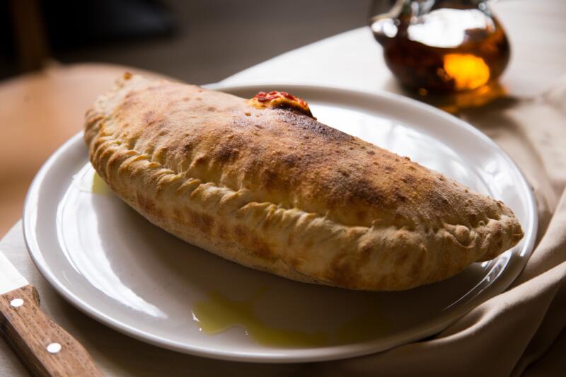 Calzone pizza on a white plate
