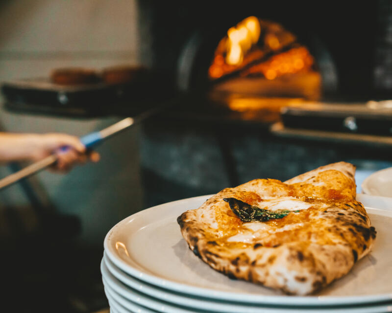 Calzone pizza on a plate ready to be served in a pizzeria