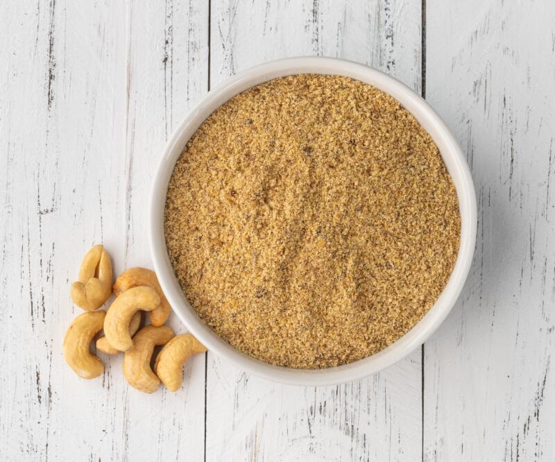 Cashew nut flour in a bowl on a wooden table