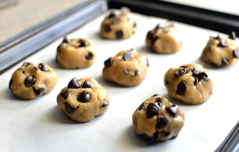 Chocolate chip cookie dough on a parchment paper 