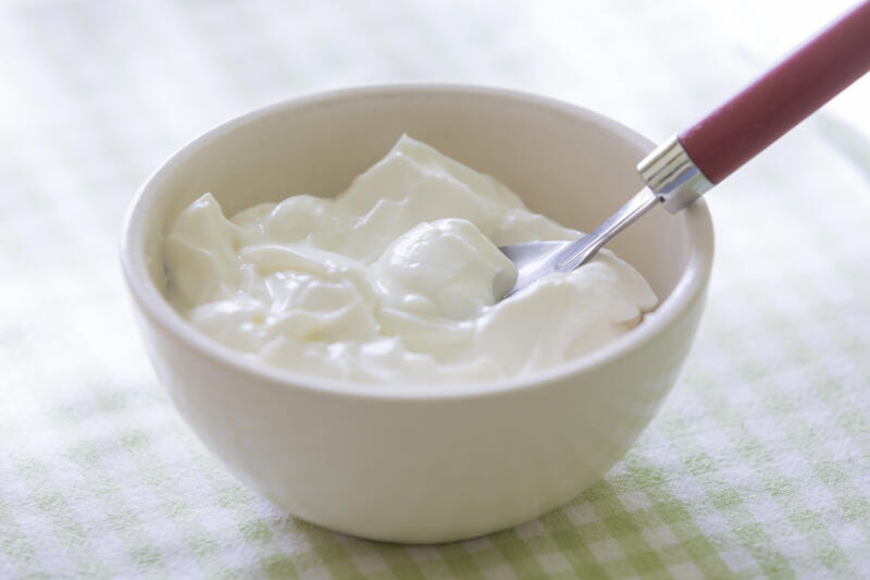 A bowl of Greek yogurt with a spoon
