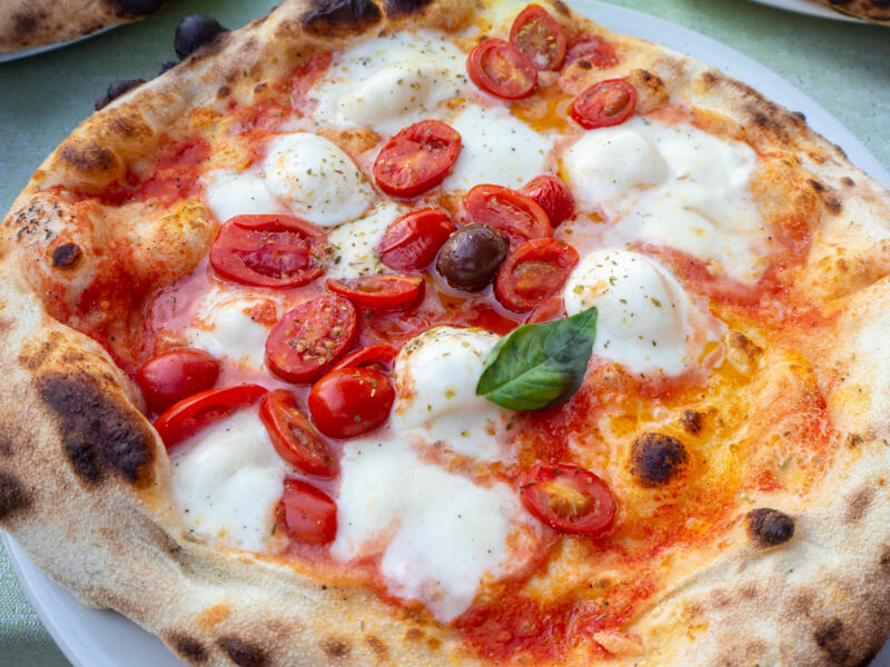 Italian Neapolitan style pizza Margherita with fresh cherry tomatoes