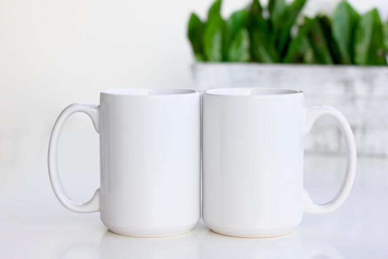 Two white mugs on a counter