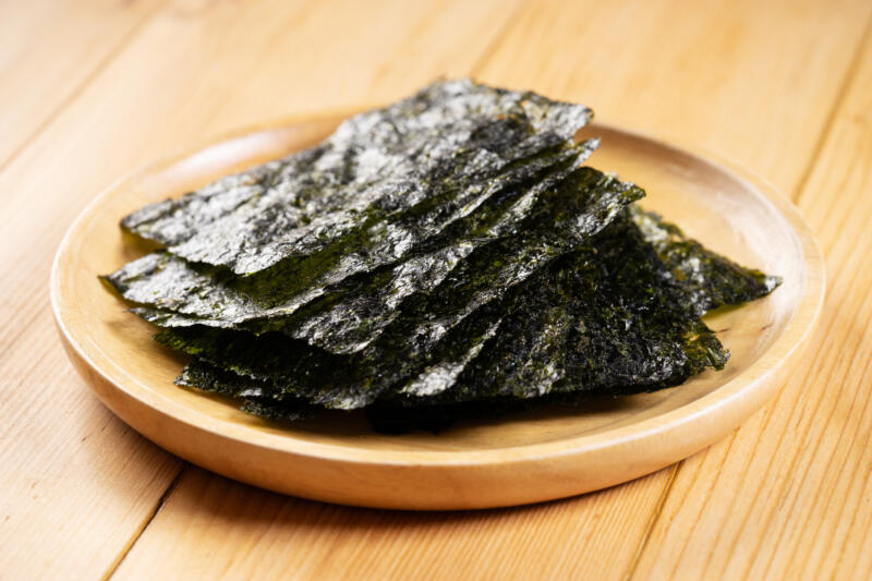 Crispy dried nori sheets in a wooden plate