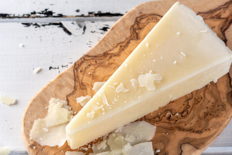 Pecorino Romano sheep milk cheese on a cutting board