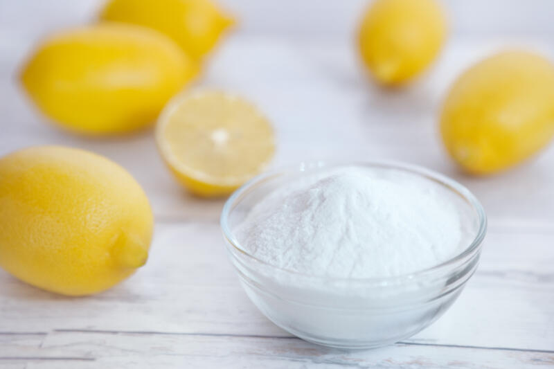 Bowl of baking soda and some lemons on the table