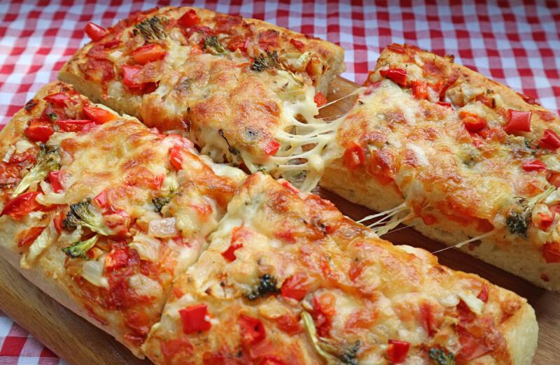 Homemade square pizza on a traditional Italian tablecloth