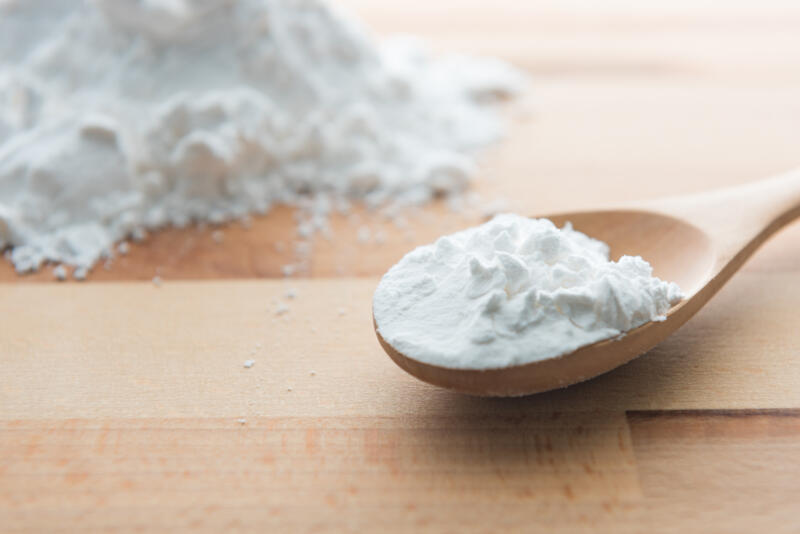 Close-up of tapioca starch in a wooden spoon