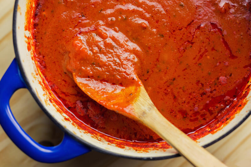 Overhead view of rich marinara sauce slowly cooked