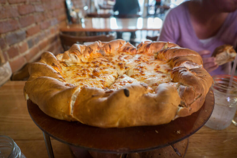 Thick-crust Colorado style cheese pizza served in a restaurant
