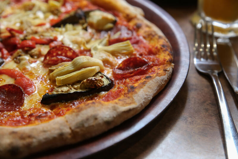 Wood-fired eggplant and artichokes pizza with pepperoni 