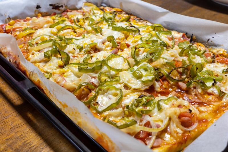 Homemade pizza al teglia in a baking tray close-up