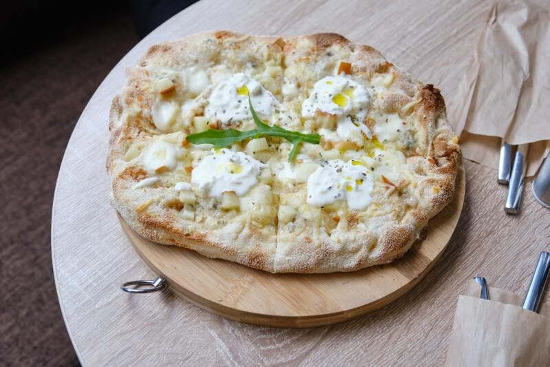 Roman white pizza or pizza bianca on a wooden serving tray