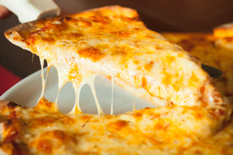 Cheese pizza cut in slices close-up