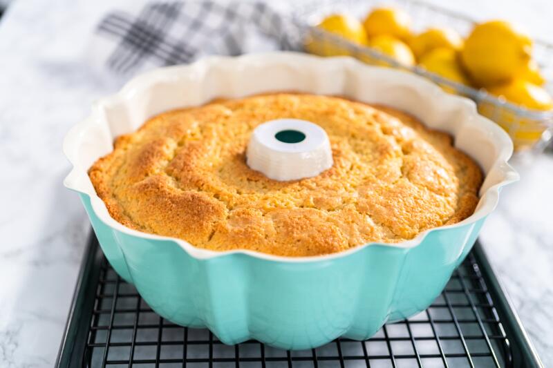 Cooling a lemon pound cake in ceramic pan on a rack