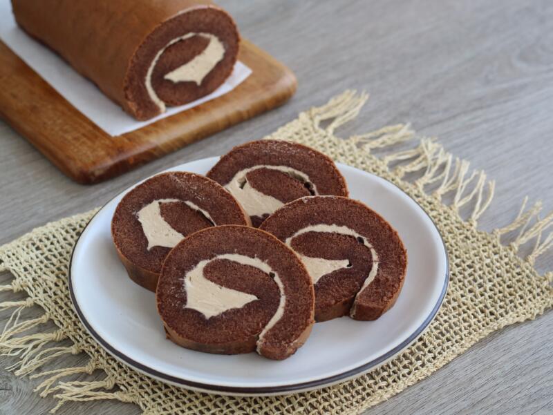 Swiss chocolate roll slices with buttercream on a plate