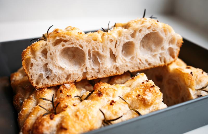 Airy, crunchy focaccia with salt and rosemary in a form