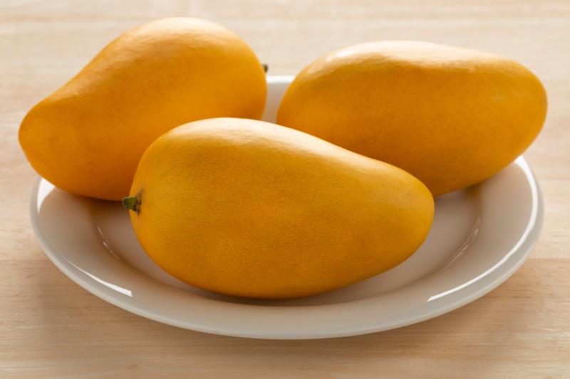 Three Nam Dok Mai mangoes on a plate