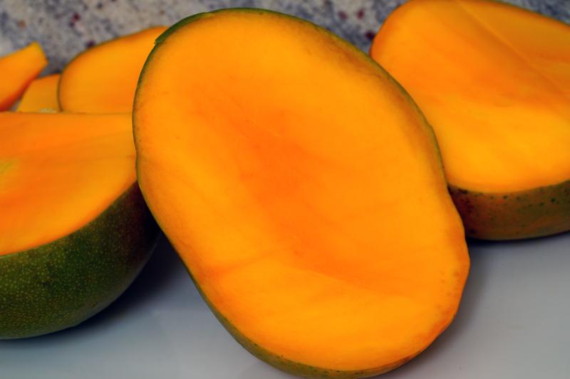 Ripe Kent variety of mango cut in half 