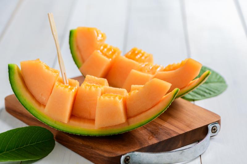 Sliced cantaloupe melon slice on its skin