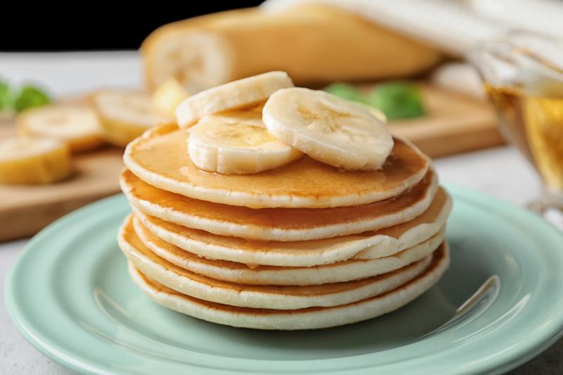 A pile of freshly baked banana pancakes on a plate