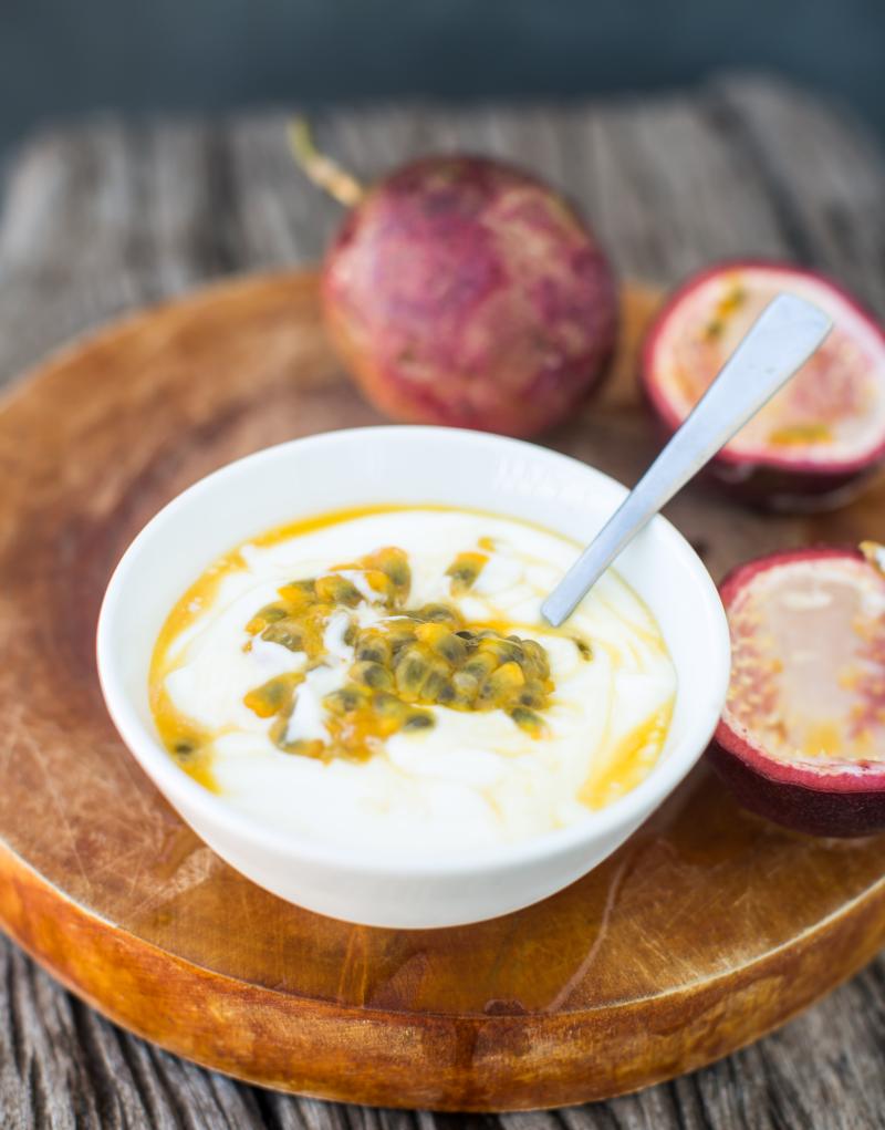 Yogurt with passion fruit in a white bowl 